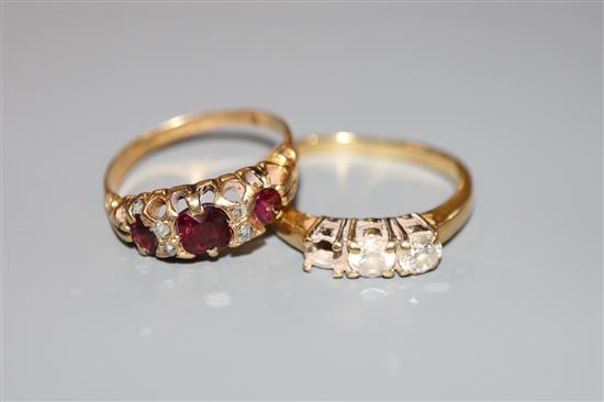 An early 20th century yellow metal, ruby? and diamond chip set ring and a modern 18ct gold and two(ex 3) stone diamond ring.